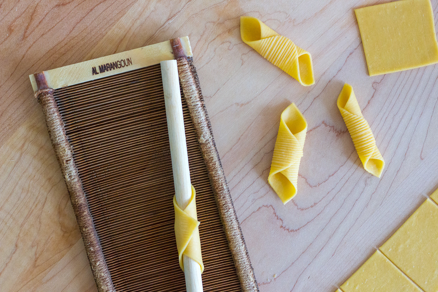 Homemade garganelli pasta with pasta comb