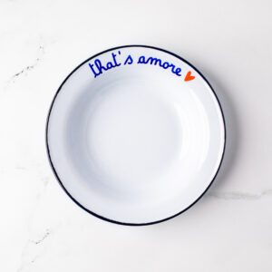 Blue rimmed bowl that has "that's amore" written on the rim in blue with a red heart at the end.