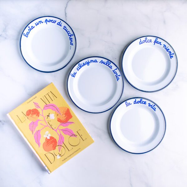 La Vita È Dolce Cookbook and four dessert plates with Italian phrases on them