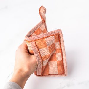 Checkered potholder with peachy tones