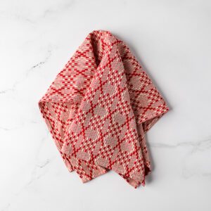 Red and white tea towel on a marble background